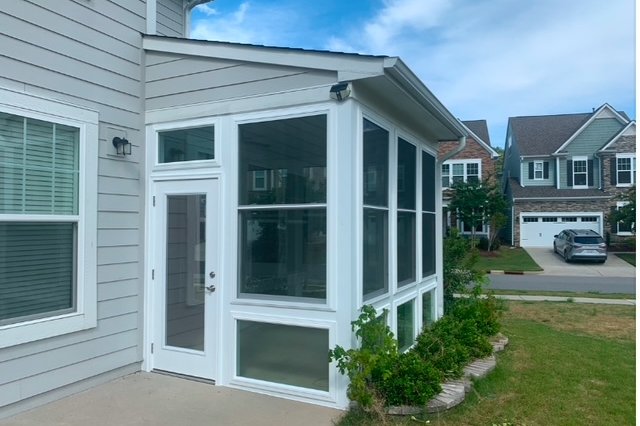 Two-story home with new windows and a glass door
