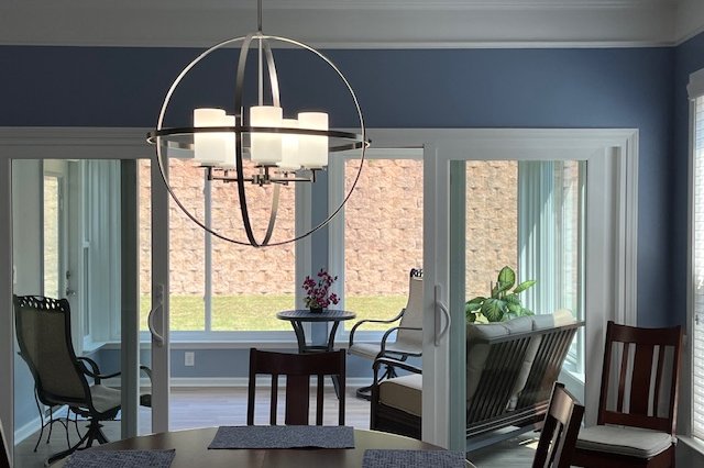 Dining room with large windows and a sliding door