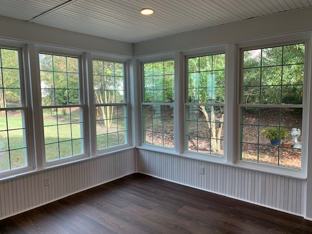 Row of white double-hung windows with grids