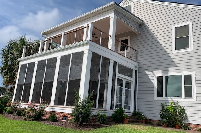 Two-story home with light gray siding and white trim