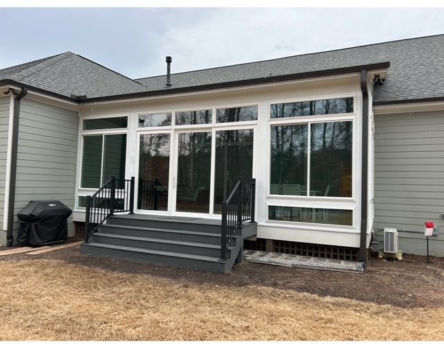 Back of a ranch home with new windows and steps