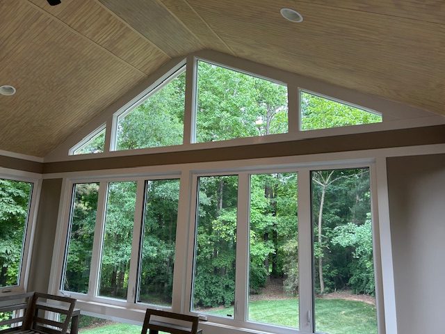 Wall of picture windows with angled transom windows above