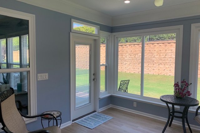 Room with new windows and a door facing the backyard