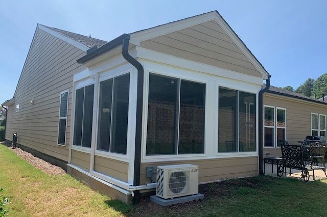 Sunroom exterior with a mini-split unit outside