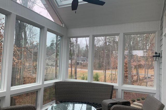 Sunroom interior with windows facing the woods