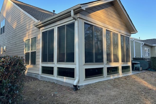 Home exterior with tan siding and white-framed windows