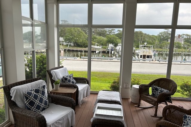 Three-season room with wicker furniture and a water view