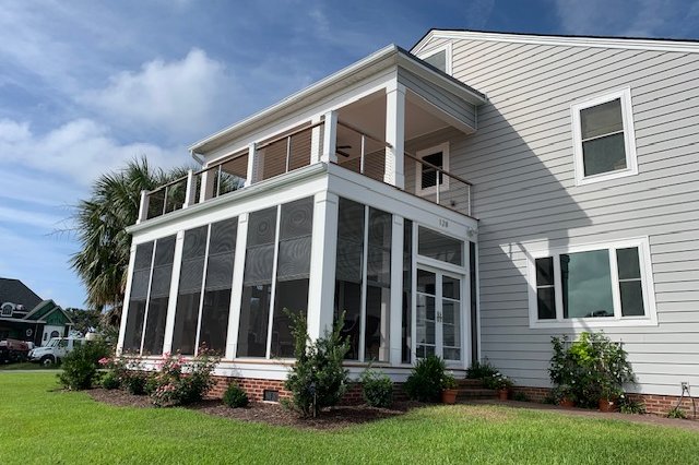 Two-story home with a row of white windows