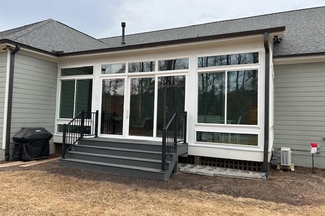 White-frame windows on the back of a gray home