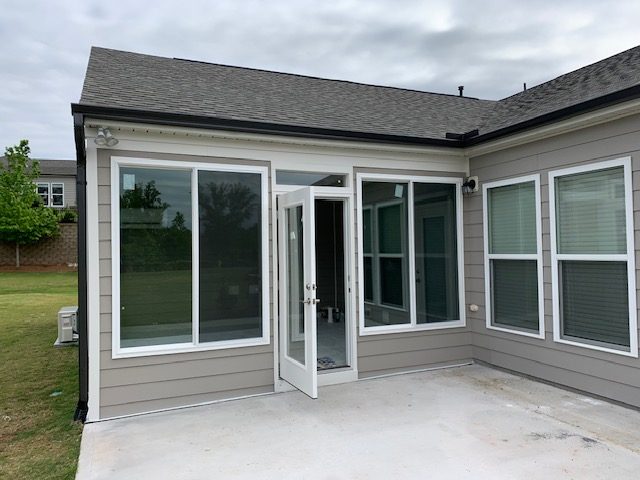 Home exterior with new replacement windows and patio door