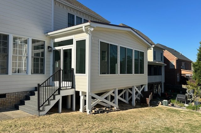 Side of a home with new windows and a raised porch